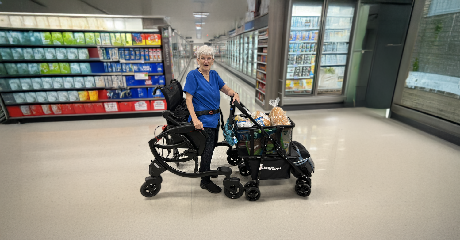 Two women on an outdoor pickleball court, one using a Zeen sit stand walker while holding a paddle, the other standing beside her ready to play.